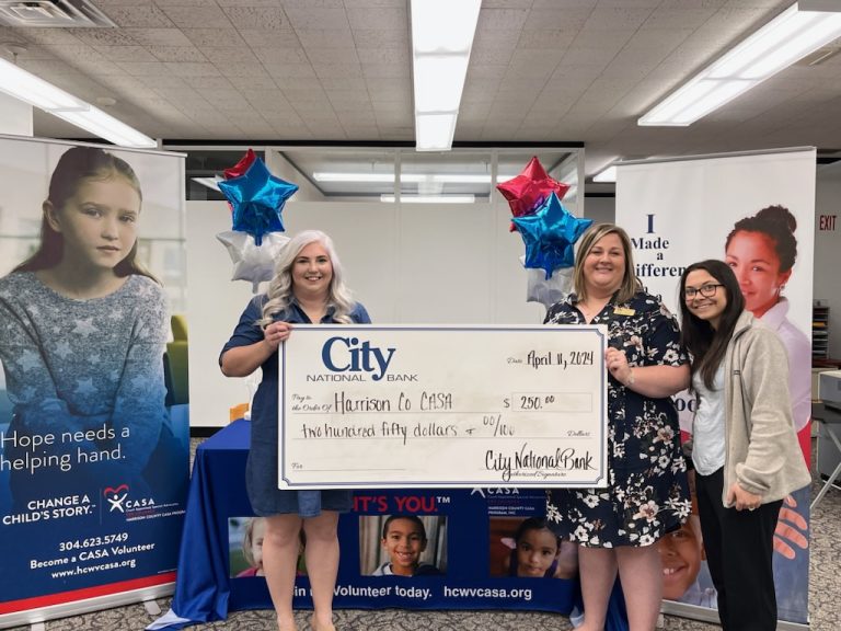 City employees posing with a big donation check