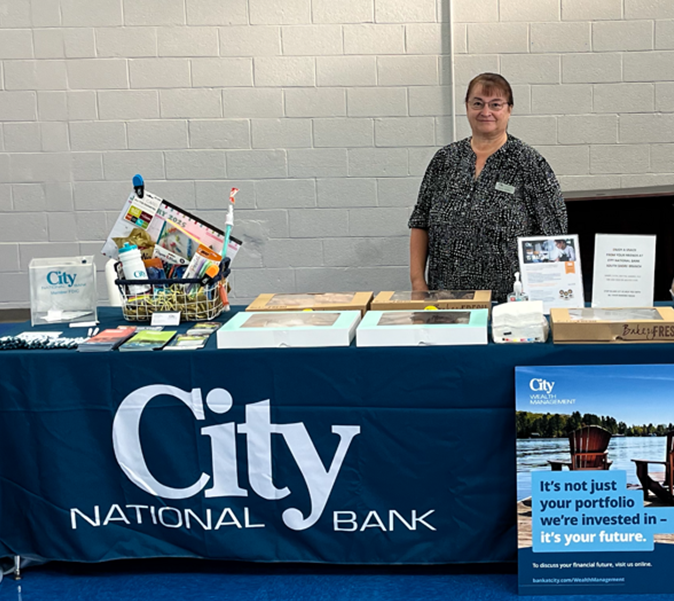 City National Bank employee posing with merchandise